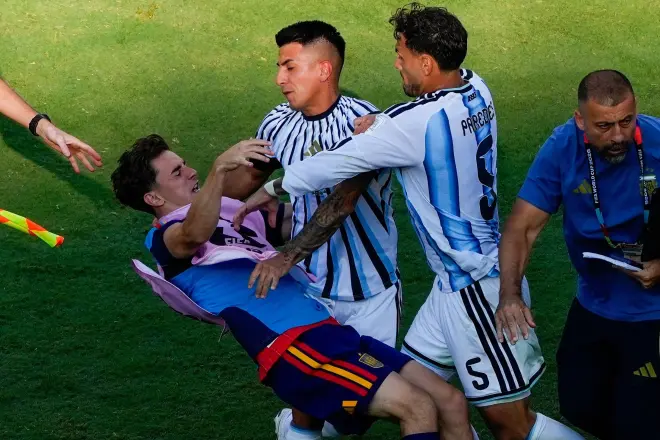 Gavi, (left) falls as he scuffles with Leandro Paredes