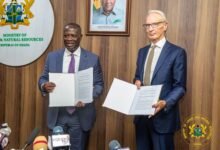 Mr Buah (left) and Mr Tait displaying the signed MOU