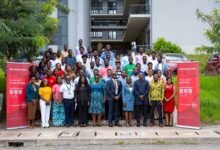 Absa officials with staff, and students after the event