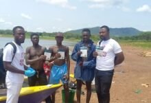 Staff of Gosanet with some fishermen after distributing HIV self-testing kits and condoms at Dzemeni