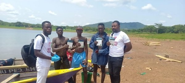 Staff of Gosanet with some fishermen after distributing HIV self-testing kits and condoms at Dzemeni