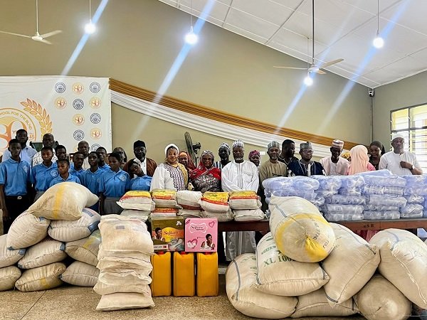Chief Kabore (sixth from right) with his family, management and students of the school after the donation