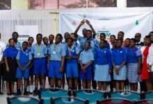 Mr Enoch Kekeli and officials of M-Hub in a group photograph with students and a teacher from Madonna School after the competition.