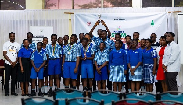 Mr Enoch Kekeli and officials of M-Hub in a group photograph with students and a teacher from Madonna School after the competition.