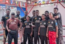 Members of the Black Bombers with head coach Asare (left)
