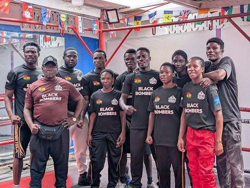 Members of the Black Bombers with head coach Asare (left)