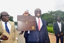 Dr Cassiel Ato Forson (middle) holding the bag containing the dudget document Photo Victor A. Buxton -