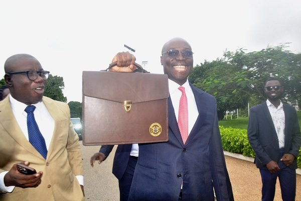 Dr Cassiel Ato Forson (middle) holding the bag containing the dudget document Photo Victor A. Buxton -