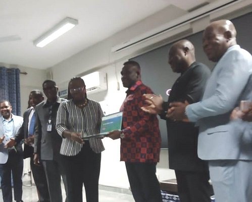 Mr George (third from right) presenting the laptops to Professor Amfo
