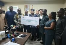 Mr Eric Opoku (third from left) receiving the dummy cheque from Mr Takyi
