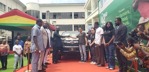 Mr Opoku (fourth from left) receiving the keys to the pickup from Mr Raab