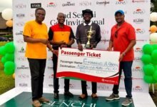 Mr A. Obeng (with trophy) receives his Business Class passenger ticket prize