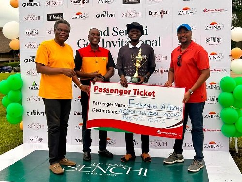 Mr A. Obeng (with trophy) receives his Business Class passenger ticket prize