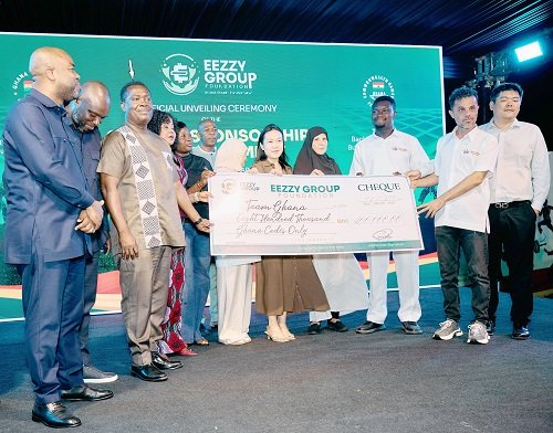 Mr Raii (right) presenting a dummy cheque to Mr Afadzinu and the CGA Ghana team