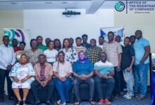Mrs Peprah (seated third from right) with other management staff and the Call Center personnel