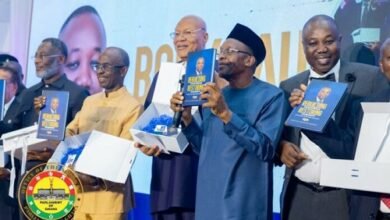 Mr Bagbin (second from right) being assisted by other dignitaries to launch the book