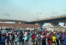 Passengers queue to board vehicles to their destinations