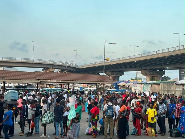 Passengers queue to board vehicles to their destinations
