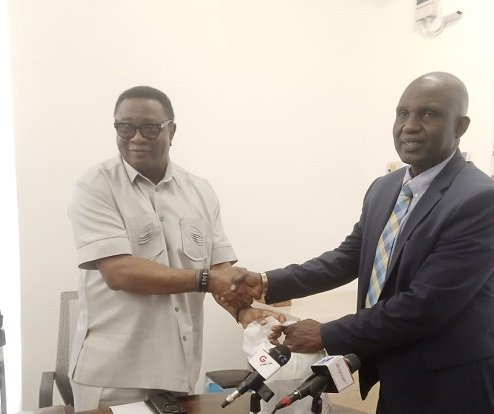 Mr Afriyie Ankrah (left) presenting the money to Dr Yakubu Seidu Adam
