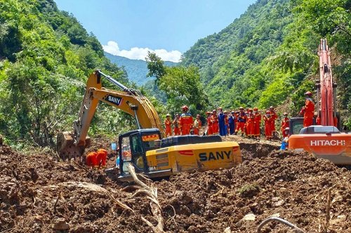 Rescuers conduct search and rescue at the site of a landslide on Tuesday