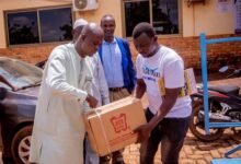 Sagnarigu Assembly ---Mr Gong presenting an item to one of the beneficiaries