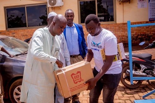 Sagnarigu Assembly ---Mr Gong presenting an item to one of the beneficiaries