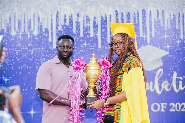 Dr Atta Kumah (left) presenting the trophy to Ms Caromon K. Appiah at the ceremony