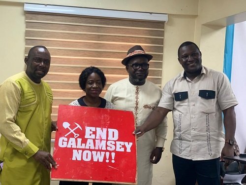 Mr. Ashigbey, (third from left), Mr. Daryl Bosu (right) and others displaying a placard at the press conference