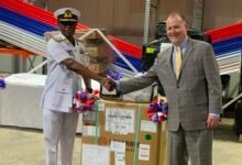 Rear Admiral Bessing (left) receiving the equipment from Mr Olson