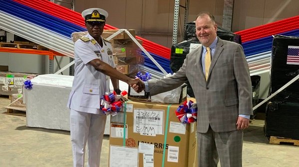 Rear Admiral Bessing (left) receiving the equipment from Mr Olson