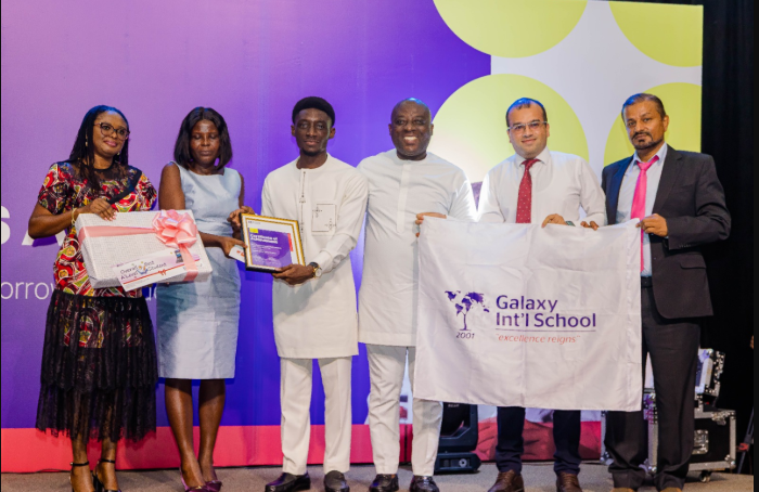 Mrs Oduro, (second from left) presenting an award to Nana Kwaku Amoako Oduro Mensah(fourth from right), from Galaxy International School as the overall student, while other dignitaries look on