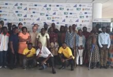 Mr Hammond (squatting middle) with other participants at the training programme