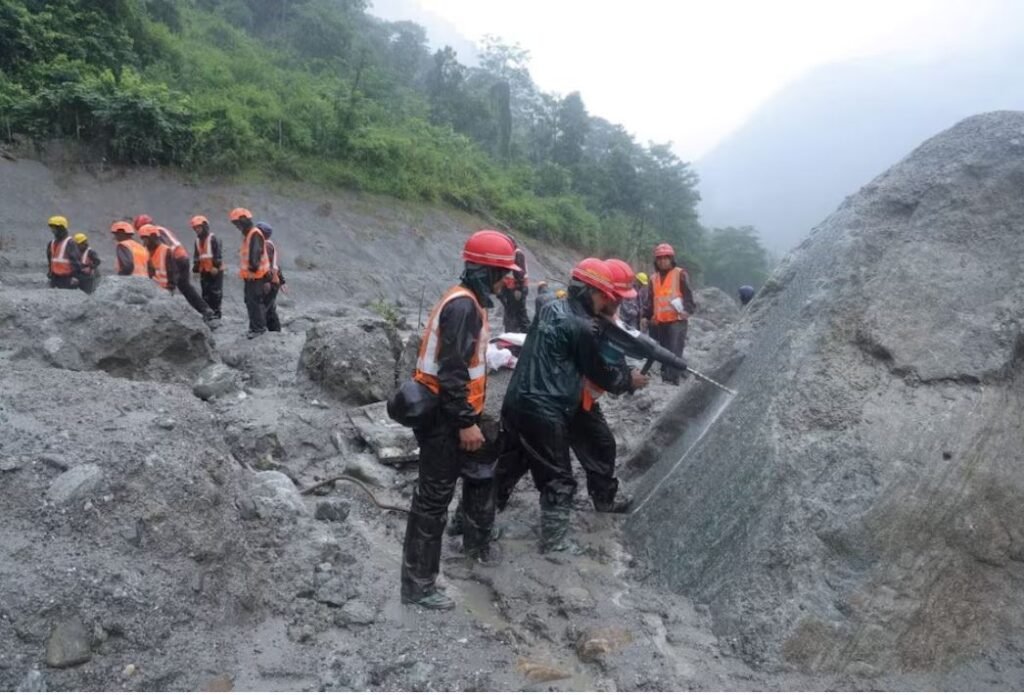 A photo of rescue workers taking part in a rescue operation near the tunnel of the Trishuli 3A Hydropower Project, following deadly flash floods and mudslides, in Rasuwa, Nepal