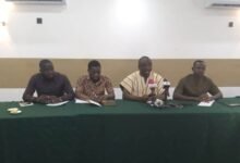 Dr Frimpong (second from right) speaking at the programme. With him are other AFAG members