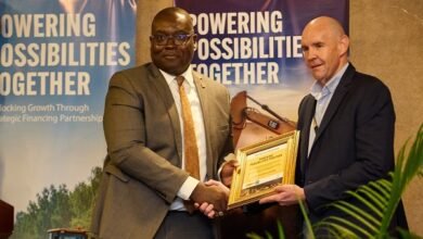 Mr Hill (right) and an official of Access Bank exchanging the signed document
