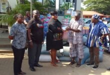 Ms Nongo (third from left) presenting the items to Nii Akpor