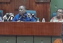 Mr John Kapi (middle) addressing the press conference