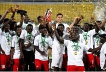 Asante Kotoko players celebrating with the Democracy Cup after beating Hearts on penalty shoot-outs