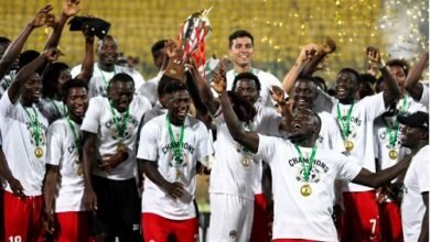 Asante Kotoko players celebrating with the Democracy Cup after beating Hearts on penalty shoot-outs