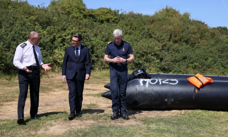 Britain’s Prime Minister Andy Burnham, centre, speaking with John Craig, Interim Chief Coastguard, and Duncan Capps, Border Security Commander (DG BSC), left
