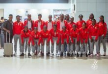 Coach Sampson (left) with the players before departure