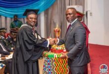 Mr Asante (left), receiving an award from Mr Adjei