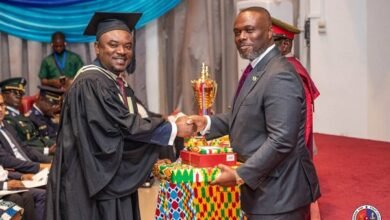 Mr Asante (left), receiving an award from Mr Adjei