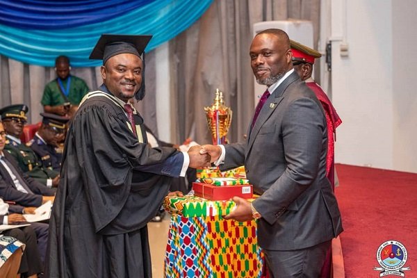 Mr Asante (left), receiving an award from Mr Adjei