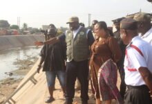• Mr Kpakpo Allotey, (hand raised) Chief Executive of AMA, brief ing Ms. Linda Ocloo (second from right) on the impact of the June 29 floods at Alajo during an inspection tour. Photo: Ebo Gorman