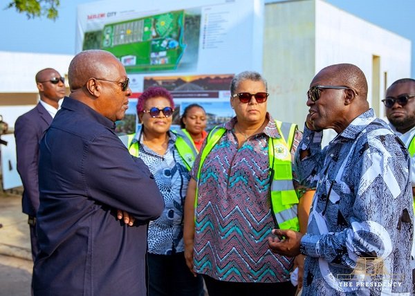 President (left) being briefed during his working visit to the Saglemi Housing project
