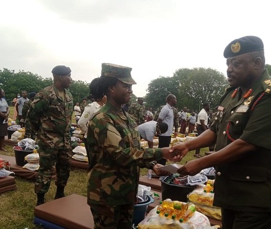 Lt. Gen. W. Agyapong presenting the items to one of the victims