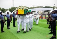 Military pallbearers carrying the remains of the late Ambassador James Victor Gbeho for burial