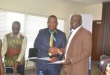 Mr Adjei (right) exchanging pleasantries with Mr Moukala after signing the MOU at the ceremony Photo Victor A. Buxton