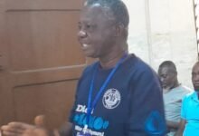 Mr Barnie (inset) addressing residents of Agbogbloshie in Accra